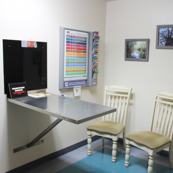 A small office featuring a desk and chairs